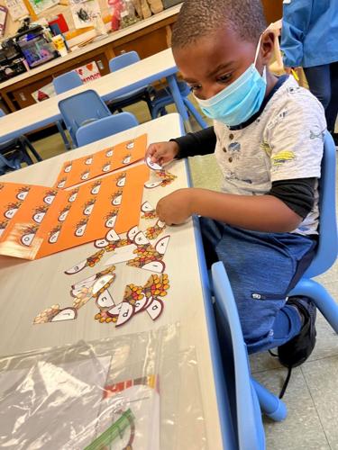Child in Head Start program plays letter-sorting game